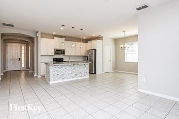 Davenport house for rent - a large kitchen with white cabinets and a marble counter top