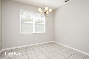 Davenport house for rent - an empty dining room with a window and a chandelier