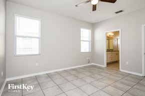 Davenport house for rent - a living room with a tile floor and a ceiling fan
