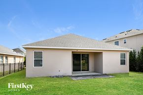 Davenport house for rent - a small white house with a grassy yard and a fence