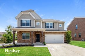 Gastonia house for rent - a brick house with a white garage door