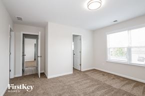 Gastonia house for rent - a living room with a carpeted floor and a large window