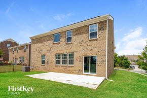 Gastonia house for rent - a brick building with a white sidewalk in front of it