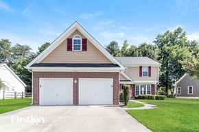 Charlotte house for rent - a brick house with a white garage door in front of a lawn