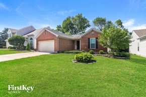 Mason house for rent - a brick house with a lawn and a white garage door