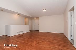 Mason house for rent - the living room and dining room with hardwood flooring and white walls