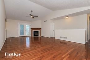 Mason house for rent - the living room with hardwood floors and a fireplace