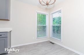 Mason house for rent - the living room of a home with two windows and a kitchen