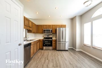 Indianapolis house for rent - A kitchen with wooden cabinets and stainless steel appliances.