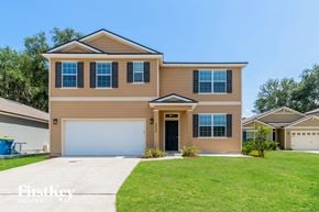 Jacksonville house for rent - a house with a garage door and a lawn
