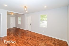 Collierville house for rent - the living room with hardwood flooring and a window