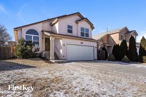Fountain house for rent - a house with a snow covered driveway and a garage door