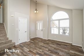 Fountain house for rent - an empty living room with a large window and a staircase