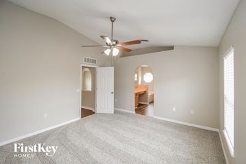 Middleburg house for rent - a spacious living room with carpet and a ceiling fan