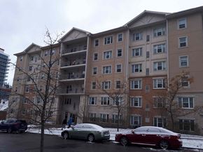 Waterloo apartment for rent - an apartment building with cars parked outside in the snow