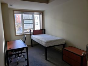Waterloo apartment for rent - a bedroom with a bed and a desk and a window