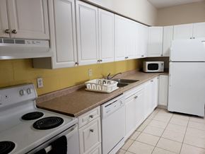 Waterloo apartment for rent - a kitchen with white appliances and white cabinets