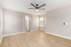 Avondale house for rent - A room with a ceiling fan and wooden flooring.