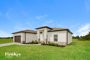 Cape Coral house for rent - A house with a lawn in front of it and the words "FirstKey Homes" on the bottom left.