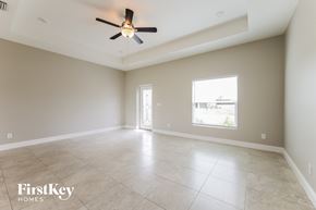 Cape Coral house for rent - A spacious room with a ceiling fan and a large window.