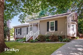 Gastonia house for rent - a white house with black shutters and a sidewalk