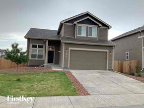 Colorado Springs house for rent - a house with a driveway and a garage door