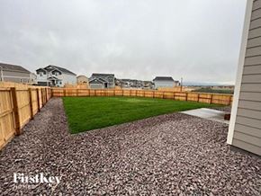 Colorado Springs house for rent - a backyard with a wooden fence and grass