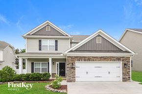 Clemmons house for rent - a house with a white garage door in front of it