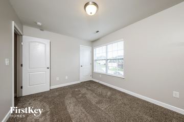 Clemmons house for rent - a spacious living room with carpet and a window