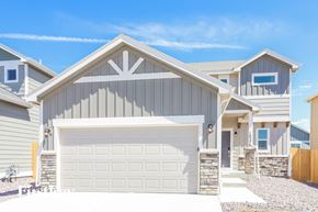Colorado Springs house for rent - a gray house with a white garage door
