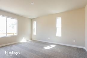 Colorado Springs house for rent - a living room with a carpeted floor and two windows