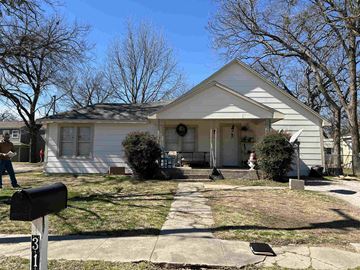 Gainesville house for rent - A white house with a black mailbox on the sidewalk.