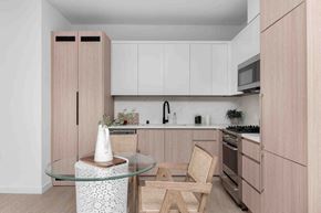 Los Angeles apartment for rent - a kitchen with wooden cabinets and a table with two chairs