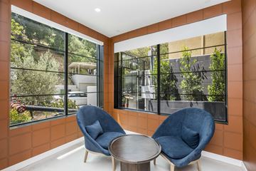 Los Angeles apartment for rent - a living room with blue chairs and large windows