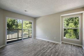 Columbia apartment for rent - an empty living room with large windows and a balcony