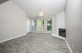 Columbia apartment for rent - an empty living room with a fireplace and a ceiling fan