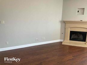 Fort Worth house for rent - a living room with a fireplace and wooden floors