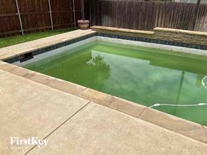 Fort Worth house for rent - a pool filled with green water in a backyard