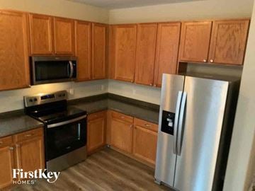 Colorado Springs house for rent - A kitchen with wooden cabinets and a stainless steel refrigerator.