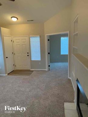 Colorado Springs house for rent - A carpeted room with a door and a window.