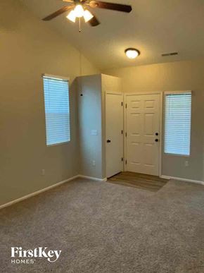 Colorado Springs house for rent - A room with a ceiling fan and two doors.