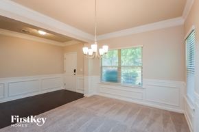 Covington house for rent - a dining room with a chandelier and a window