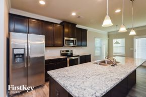 Covington house for rent - a kitchen with granite counter tops and stainless steel appliances