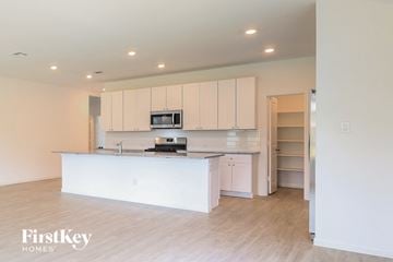 San Antonio house for rent - a white kitchen with a large island and white cabinets