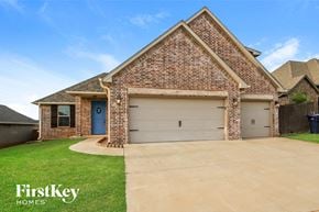Edmond house for rent - a house with a driveway and a garage door