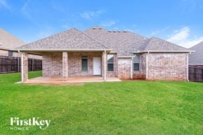 Edmond house for rent - front view of a brick house with a yard and grass