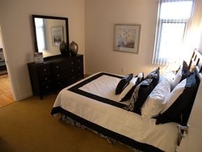 Los Angeles apartment for rent - a bedroom with a bed with pillows and a dresser and a mirror