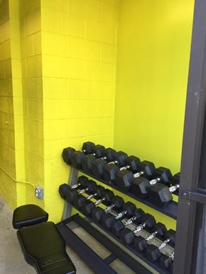 Los Angeles apartment for rent - a rack of dumbbells in a gym with a yellow wall