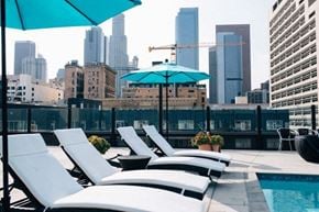 Los Angeles apartment for rent - a group of lounge chairs sitting next to a swimming pool