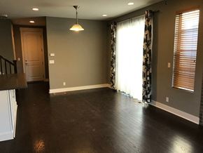 Lakewood house for rent - an empty living room with hard wood floors and a window